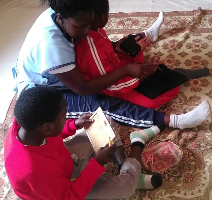 A learner making beaded jewellery