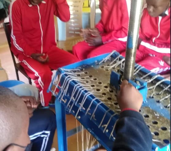 A learner making candles